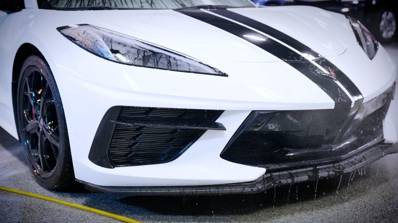 Front bumper and headlight of a white Chevrolet Corvette